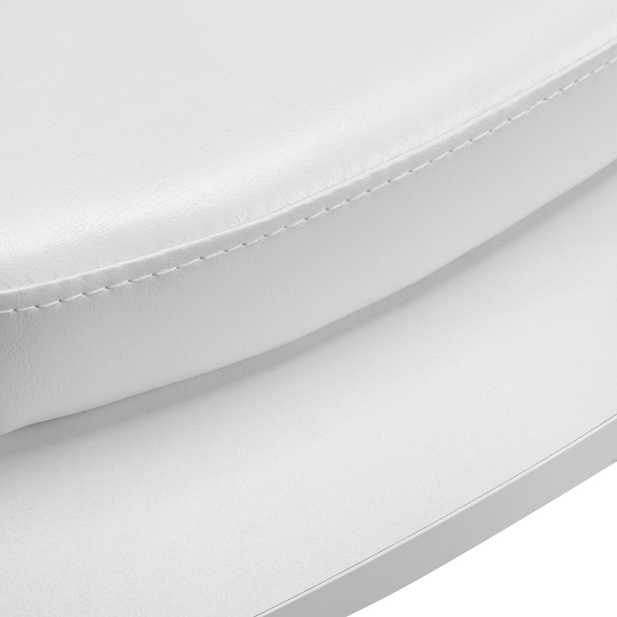 Close-up of white leatherette cushion with visible stitching.