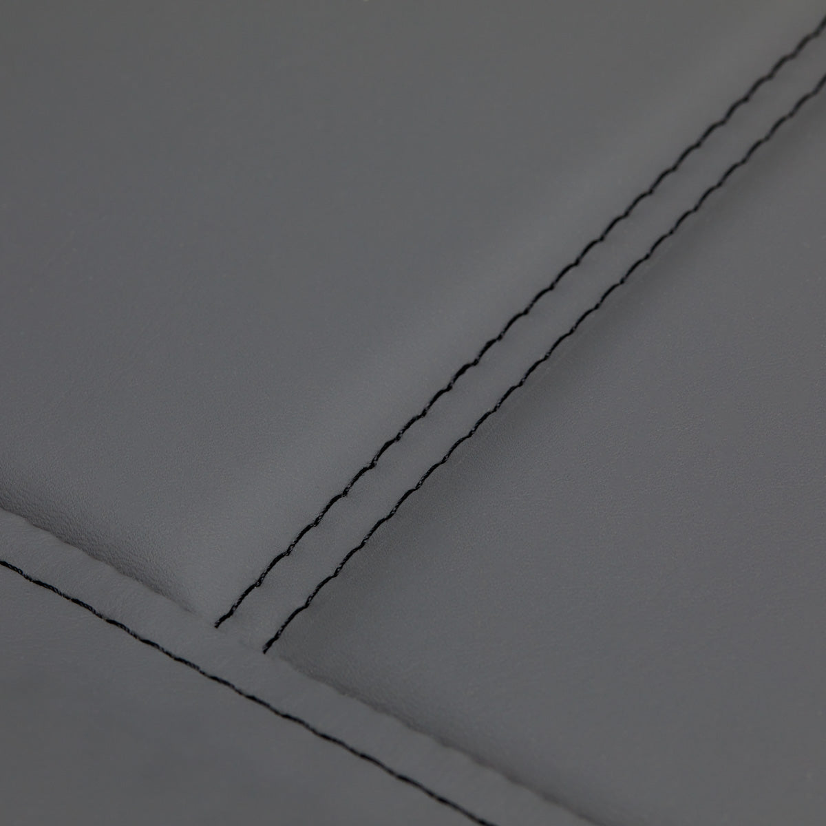 Close-up of Sillon Lux 273B treatment chair grey upholstery with double-stitched seams.