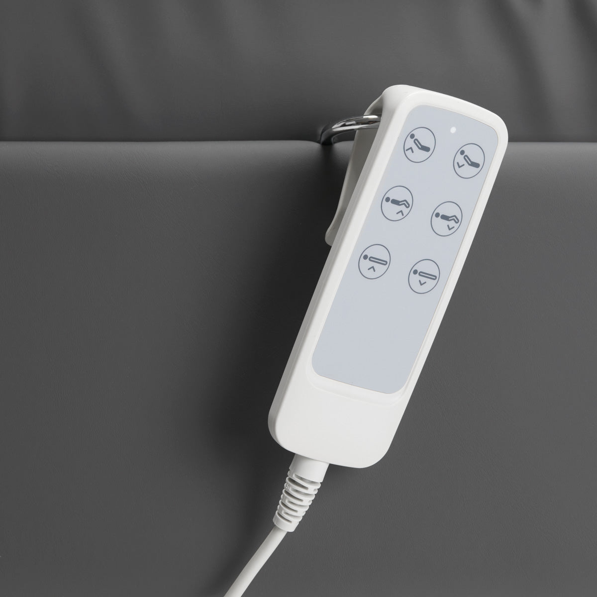 Handheld remote for Sillon Lux 273B electric treatment chair with six function icons